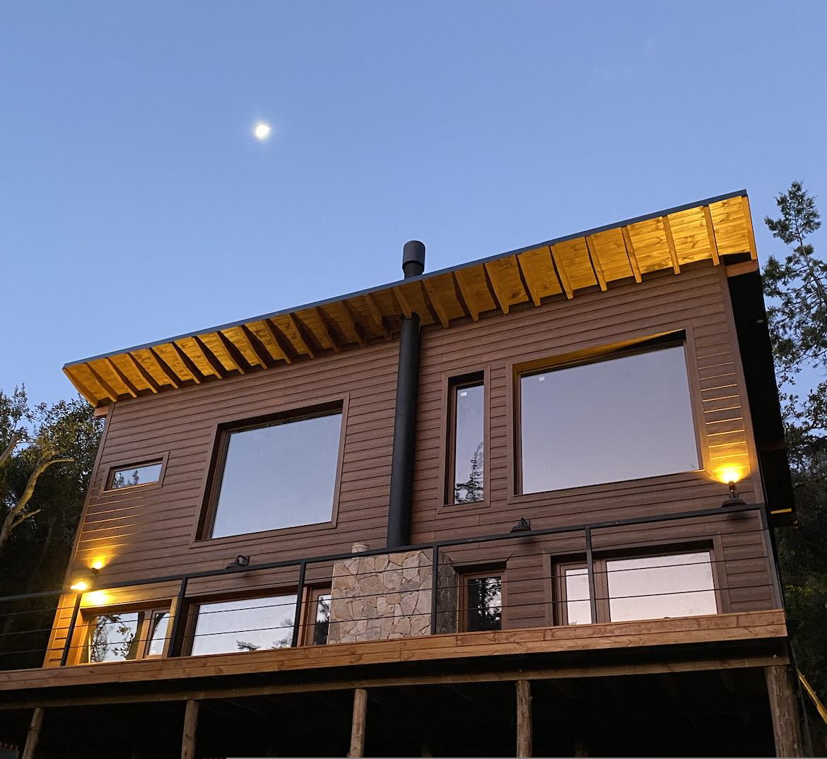 Living de una casa en Península San Pedro con vista al bosque